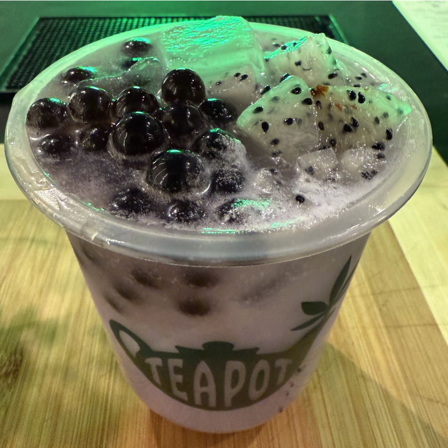 Blueberries and dragon fruit topping a cup on a table
